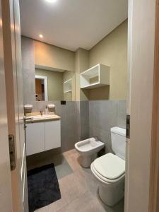 a bathroom with a toilet and a sink at Nexo Playa Depto 6 in Valeria del Mar