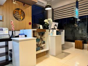 a store with two counters with flowers on it at Soi Suites in Talibon