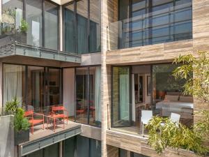 an external view of a building with glass windows at Ubicuo Hotel Boutique in Mexico City
