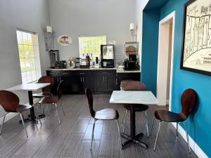 a waiting room with tables and chairs and a counter at Super 8 by Wyndham Bay St. Louis in Bay Saint Louis