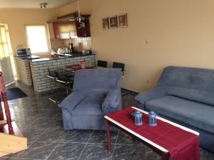 a living room with a couch and a table at Daja Ház in Hévíz