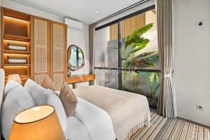 Ένα ή περισσότερα κρεβάτια σε δωμάτιο στο Fraja Villa by Kozystay - Jimbaran +49 φωτογραφίες