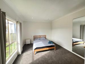 a bedroom with a bed and a mirror at Comfortable Queen Room next to Shopping Centre and Station - SH3 in Toongabbie West