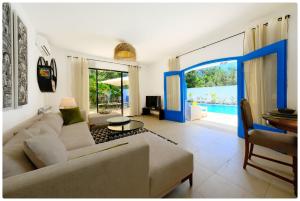 a living room with a couch and a table at Dar zeytouna in Hammamet