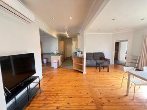 a living room with a couch and a table at Comfortable Queen Room close to Station and Shops - SH4 in Toongabbie West