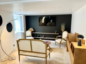 a living room with a couch and chairs at Duplex cosy 2 chambres in Vals-les-Bains +4 photos