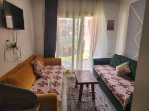 a living room with a couch and a table at بورتو مطروح ألهاني families only in Marsa Matruh