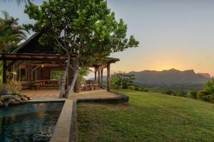 a house on a hill with a pool at La Vieille Cheminee in Chamarel