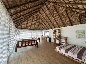 a bedroom with a bed and a desk in a room at Papapa grecas in Zipolite