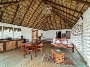 a living room with a table and a couch at Papapa grecas in Zipolite