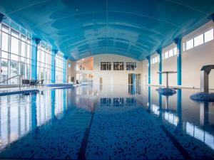 an indoor swimming pool with ducks in the water at Charleville Park Hotel & Leisure Club IRELAND in Charleville