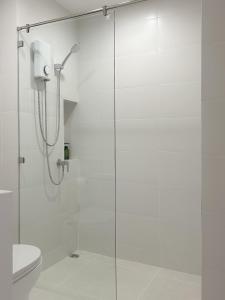 a bathroom with a glass shower with a toilet at Peace Nakhon Nayok in Nakhon Nayok +5 photos