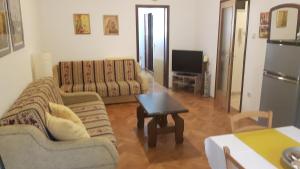 a living room with two couches and a coffee table at Apartment Bjanka in Pakoštane