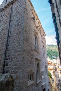 an old brick building with windows on the side at Dominus Little Palace in Dubrovnik