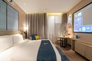 Postel nebo postele na pokoji v ubytování Echarm Hotel Nanning the MixC Exhibition Center Metro Station + 252 fotografií