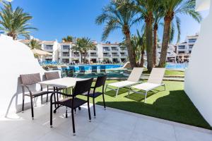 a patio with a table and chairs next to a swimming pool at Playas Ca's Saboners in Palmanova