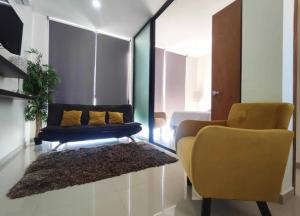 a living room with a couch and two chairs at Departamento en Mazatlán in Mazatlán