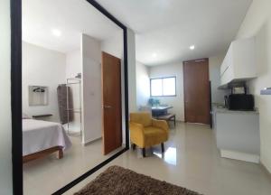 a bedroom with a mirror and a yellow chair in a room at Departamento en Mazatlán in Mazatlán +8 photos