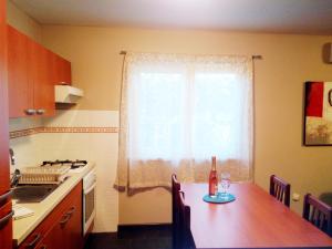 a kitchen with a table and a window with a bottle on it at Holiday Home Turalija in Vodice