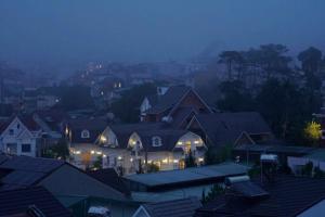 a group of houses in a city at night at TTG Hostel In Da Lat in Da Lat +27 photos