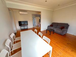 a living room with a table and chairs and a couch at Cozy Queen Room next to Shopping Centre and Station - SH5 in Toongabbie West