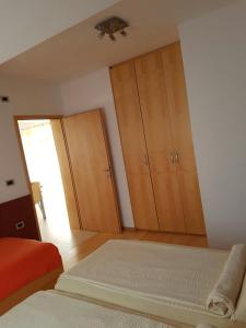 a bedroom with wooden cabinets and a bed at Apartment Lency in Novigrad Istria