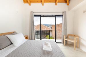a bedroom with a bed and a large window at Jungla Hotel Boutique in San Cristóbal de Las Casas