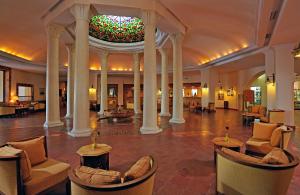 a lobby with couches and chairs and a colorful ceiling at Medina Belisaire And Thalasso in Hammamet