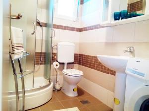 a bathroom with a toilet and a sink at Holiday Home Turalija in Vodice +12 photos