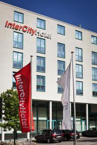 a hotel with flags in front of a building at IntercityHotel Kassel in Kassel