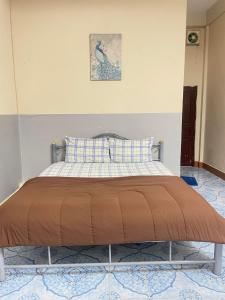 a bed sitting in a room with at Mabuhay Guest House, Thai Embassy Vientiane in Vientiane