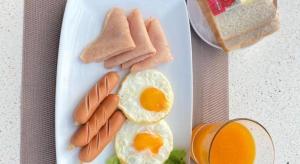 a plate of breakfast food with eggs sausage and bread at Phala Shore Resort in Ban Phala