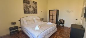 a bedroom with a bed with two towels on it at Luxury Sea Palazzo in Trani