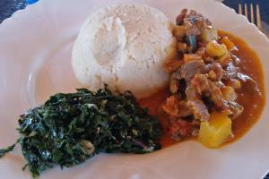 a plate of food with a scoop of ice cream at Voi Lutheran Guesthouse in Voi