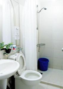 a bathroom with a toilet and a sink and a shower at Azure Staycationcation by Nairah in Manila +13 photos