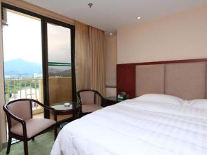 Postel nebo postele na pokoji v ubytování Gui Feng Hotel