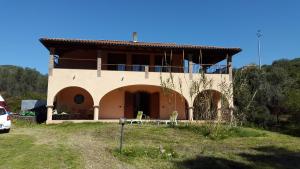 a house with a balcony on top of it at Villa l'orto Portixeddu Sardegna in Fluminimaggiore