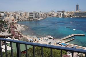 a view of a beach with boats in the water at Plaza Regency Hotels in Sliema