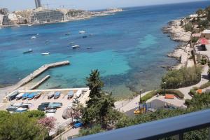 a view of a beach with boats in the water at Plaza Regency Hotels in Sliema