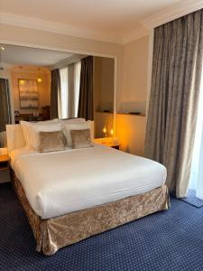 a large white bed in a hotel room at Maison LUTETIA R in Strasbourg