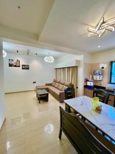 a living room with a couch and a table at 3 BHK Mount Villa by Asmeera Stays in Lonavala