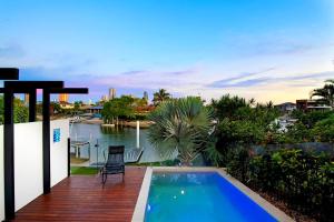 a house with a swimming pool and a deck at Wanderlust in Gold Coast