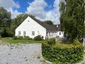 a white house with a gravel driveway at Langelinie Vin - Countryside in Frederikssund