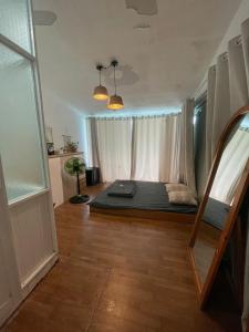 a bedroom with a bed in a room with a window at Z Camp Nha Trang in Nha Trang