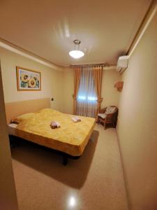 a bedroom with a bed and a chair in it at Mon petit paradis à Albir in L’Alfàs del Pi +17 photos