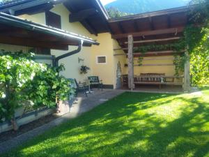 a patio of a house with a grass yard at Ferienwohnungen Berger in Kötschach