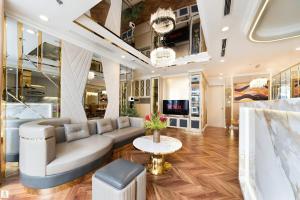 a living room with a couch and a table at The Peak Suite at Landmark Plus in Ho Chi Minh City