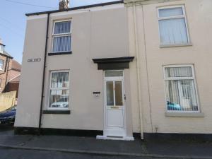 a white house with a white door and windows at Coastal Corner in Whitby