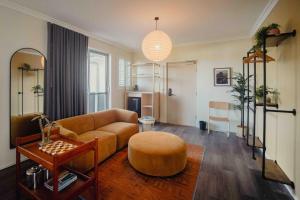 a living room with a couch and a table at Drifter Byron Bay in Byron Bay