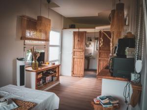 a living room with a door and a kitchen at L'Échappée des Collines - Tiny House in Frasnes-lez-Anvaing